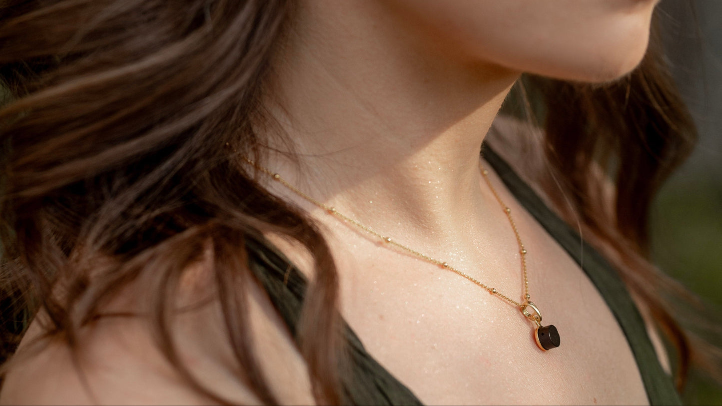black baltic amber pendant with natural amber bead